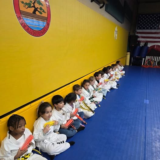 An instructor supervising Is Your Child students closely during class at Makoto Jiu Jitsu Centers in Deer Park