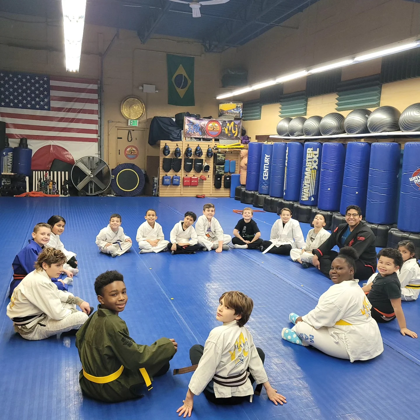 An instructor supervising Is Your Preschooler students closely during class at Makoto Jiu Jitsu Centers in Deer Park